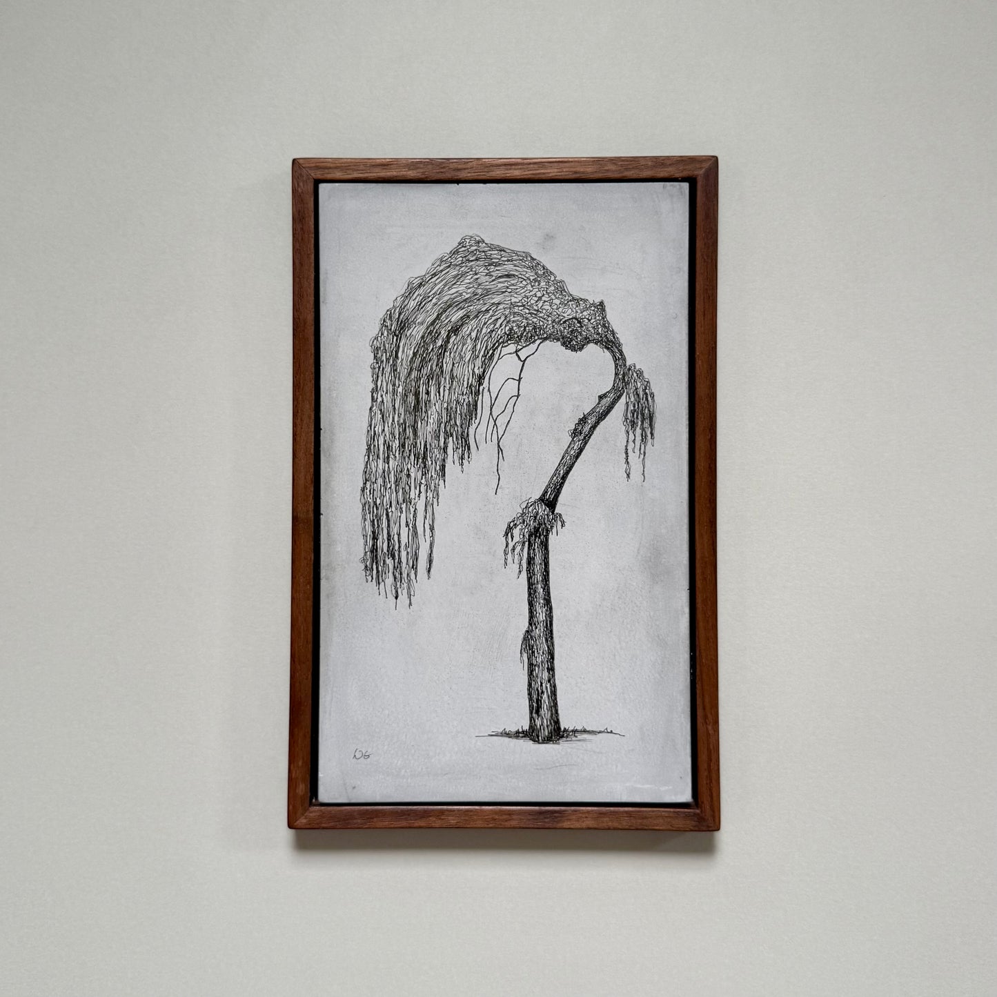 Framed original drawing of a willow tree in Dalston on cement, photographed hanging on a pale wall.