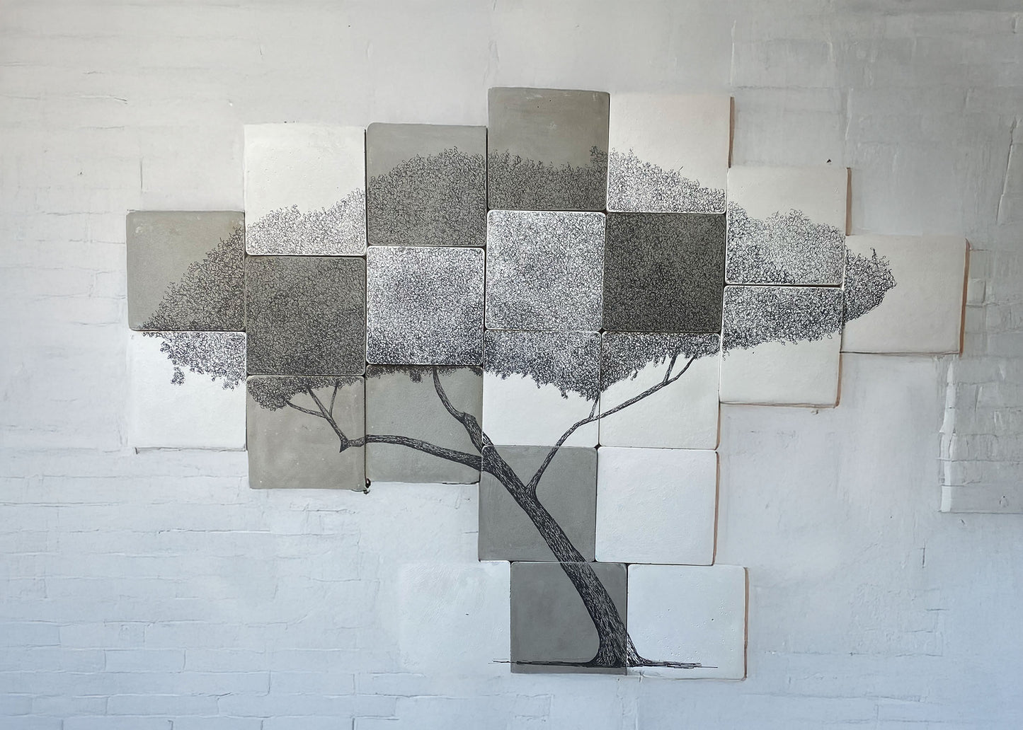 Large original tree drawing made across 24 square cement tiles, with detailed ink canopy and curving trunk.