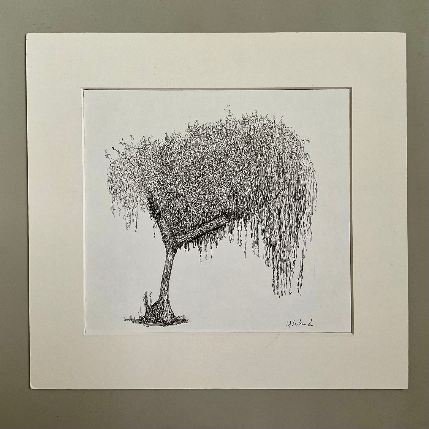 Black and white drawing of a weeping willow tree in a white frame on a beige wall.