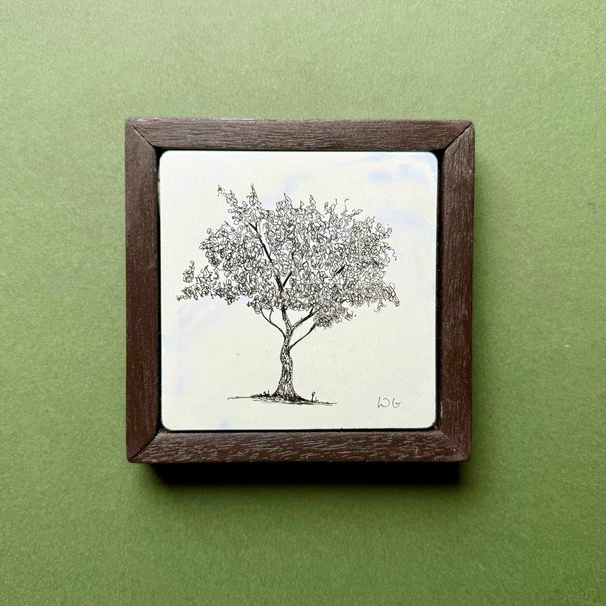 Original black ink drawing of a tree in London Fields, Hackney, on a hand-cast pigmented Portland cement tile. Featuring a delicate, densely detailed canopy, presented in a dark wooden frame against a green background.