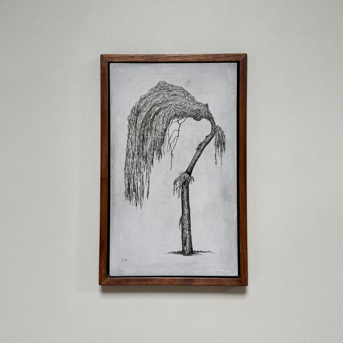 Framed original drawing of a willow tree in Dalston on cement, photographed hanging on a pale wall.