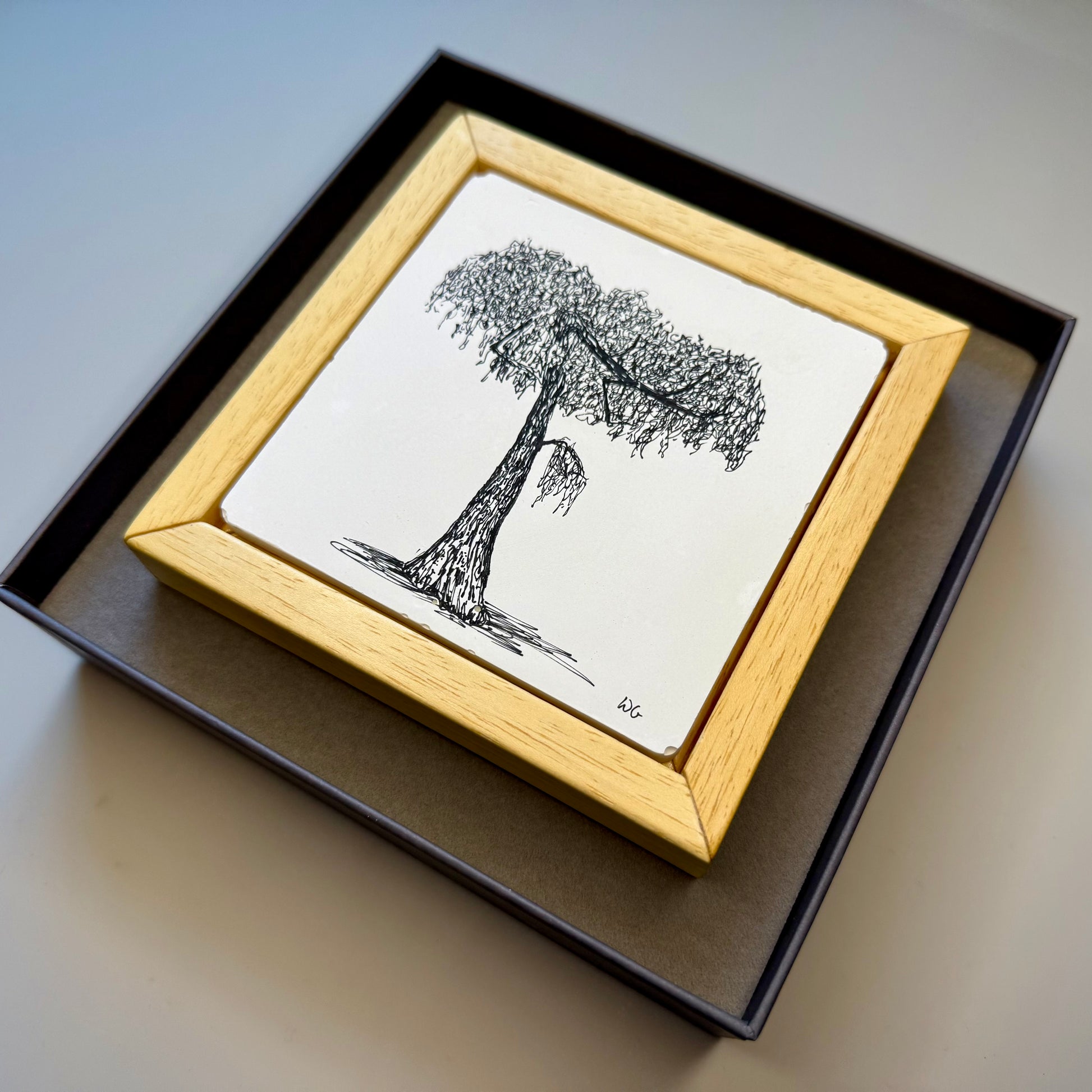 Framed black and white tree drawing in a presentation box