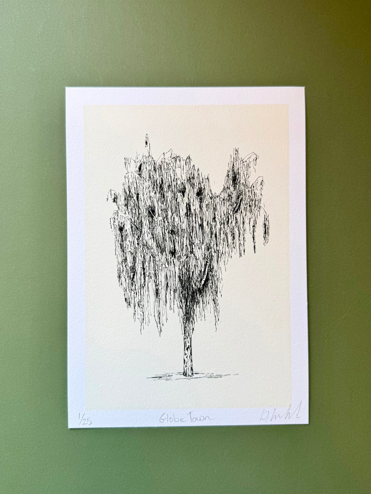 Black and white tree illustration on a light background against a green wall