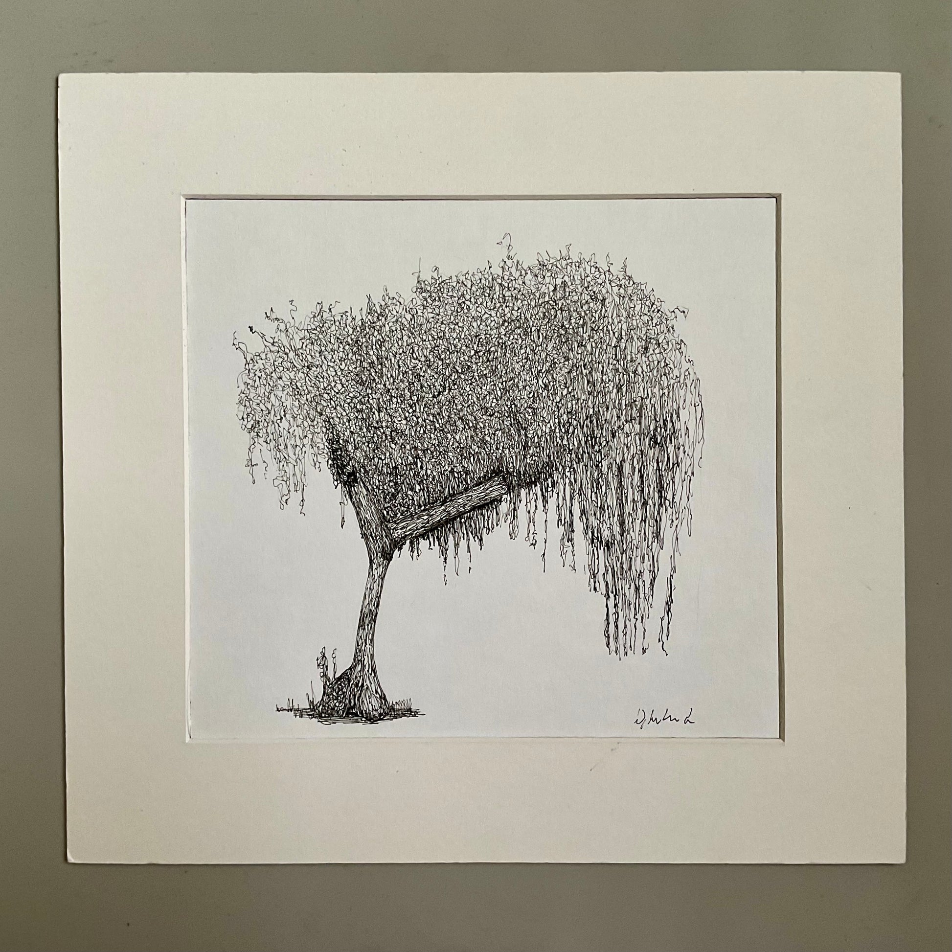 Black and white drawing of a weeping willow tree in a white frame on a beige wall.