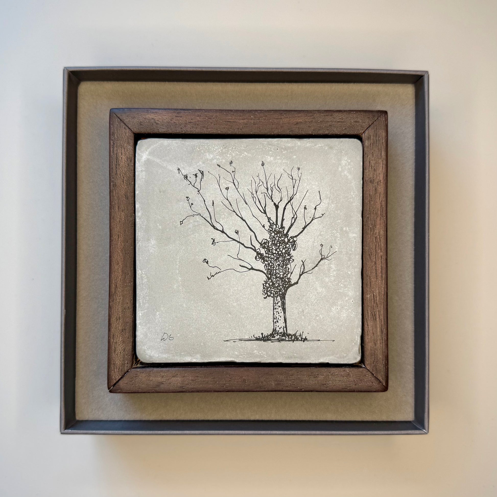 Framed artwork of a tree on a textured background