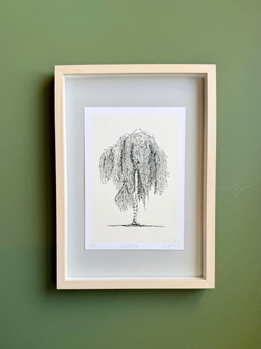 Framed artwork of a tree on a green wall