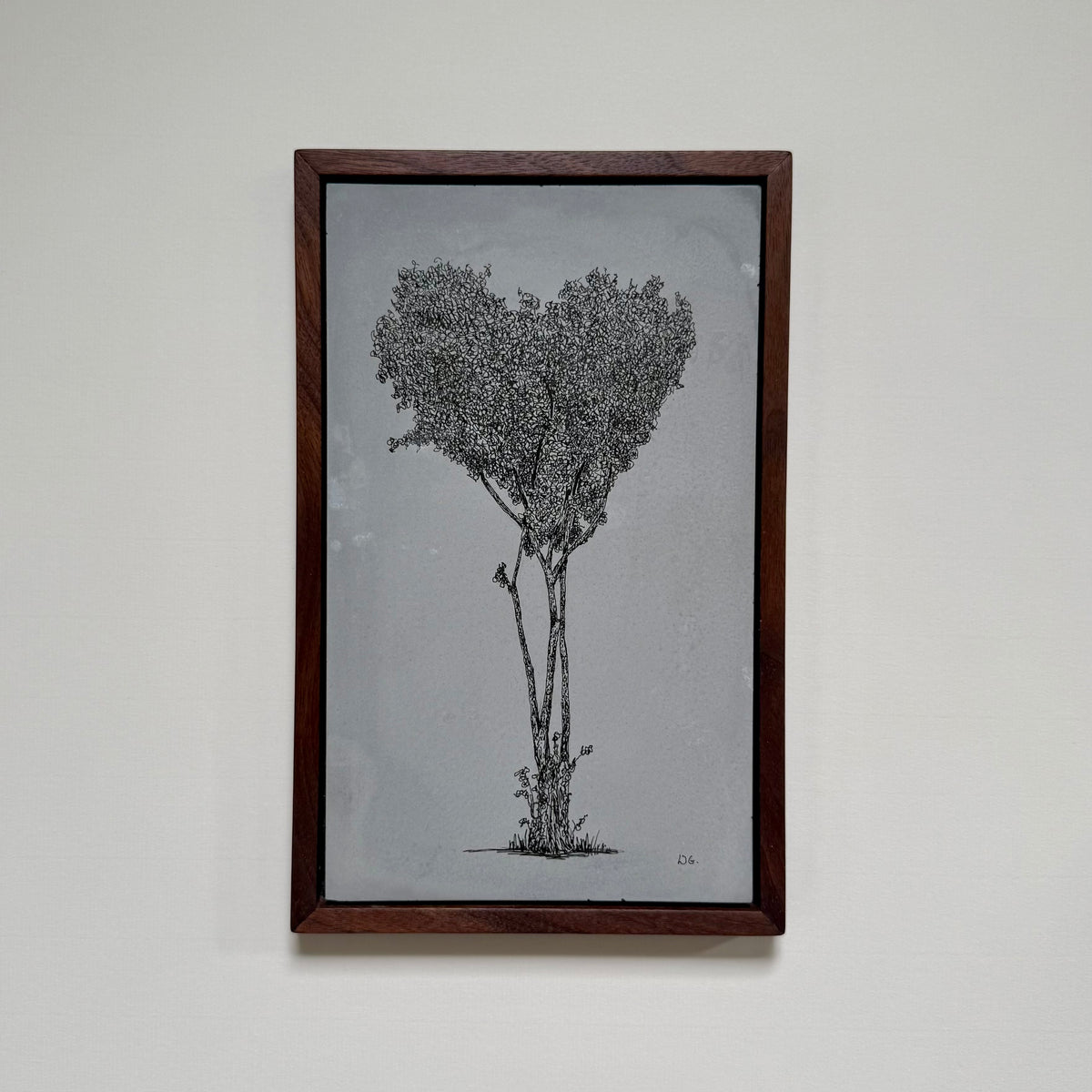 Framed original ink drawing of a tall, clustered tree on Hackney Downs, created on a hand-cast cement slab and photographed on a pale wall.