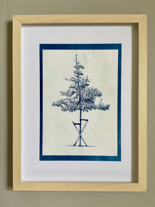 Cyanotype print of a slender tree supported by wooden stakes, printed in rich indigo tones on A4 paper.
