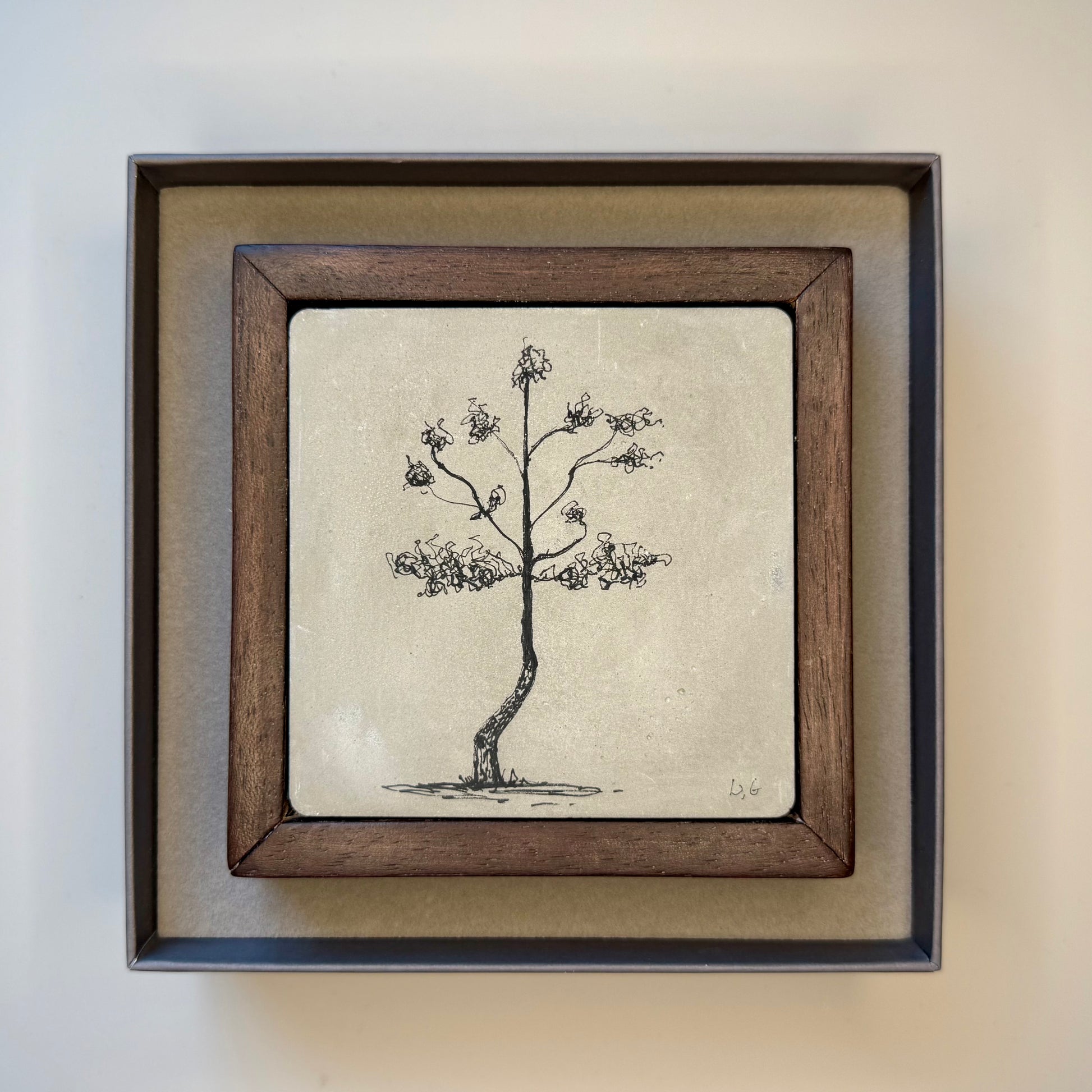 Framed artwork of a tree in a presentation box