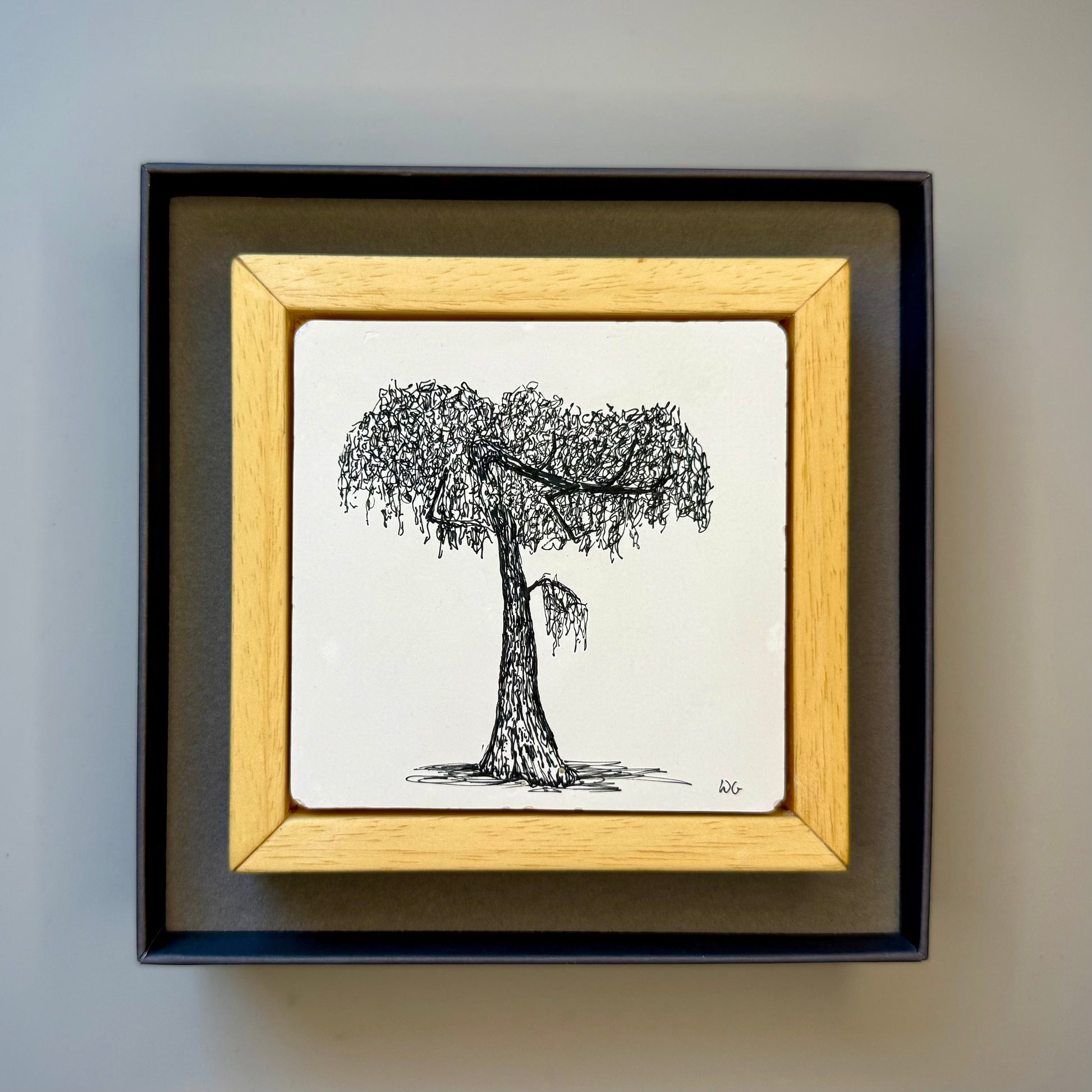 Black and white framed tree drawing in a presentation box