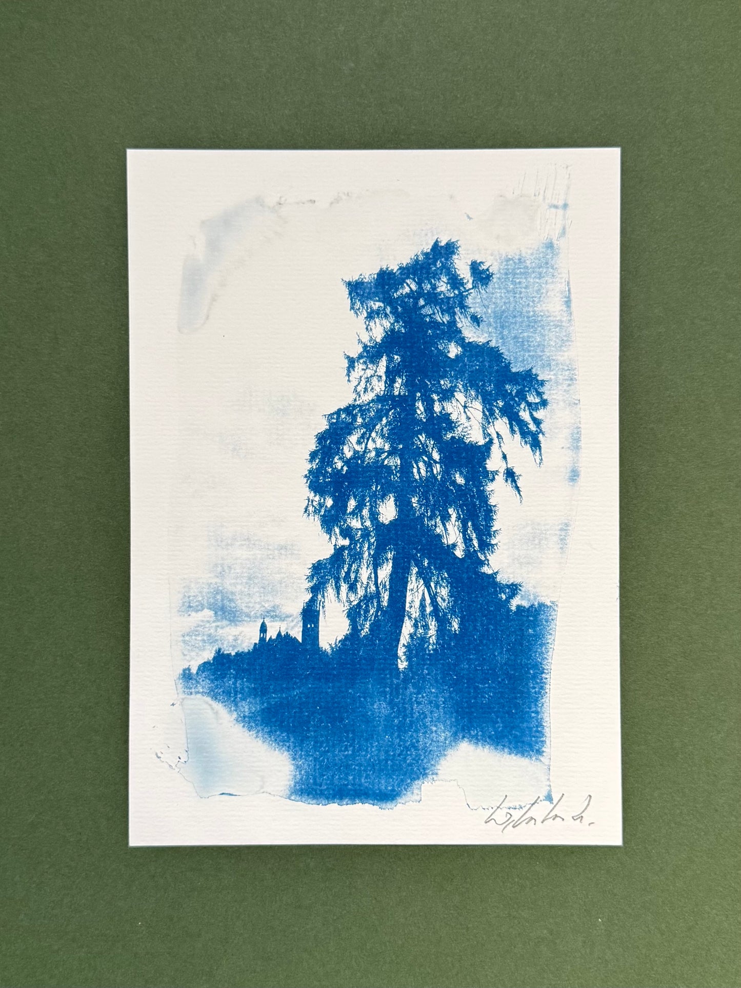 A vertical art print featuring a blue ink or watercolor tree silhouette on a white paper background, set against a solid dark green backdrop.