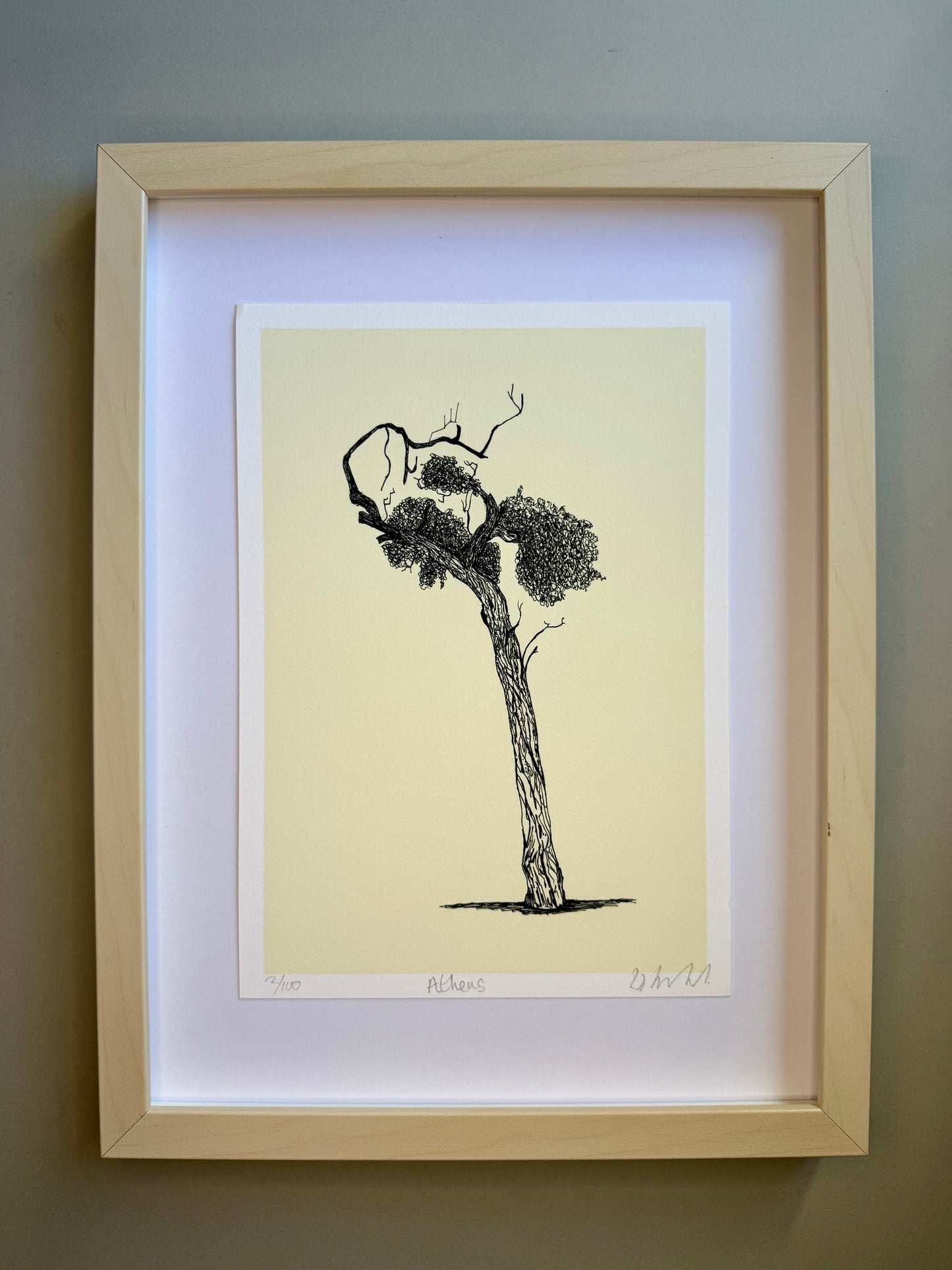 Framed artwork of a tree on a beige background