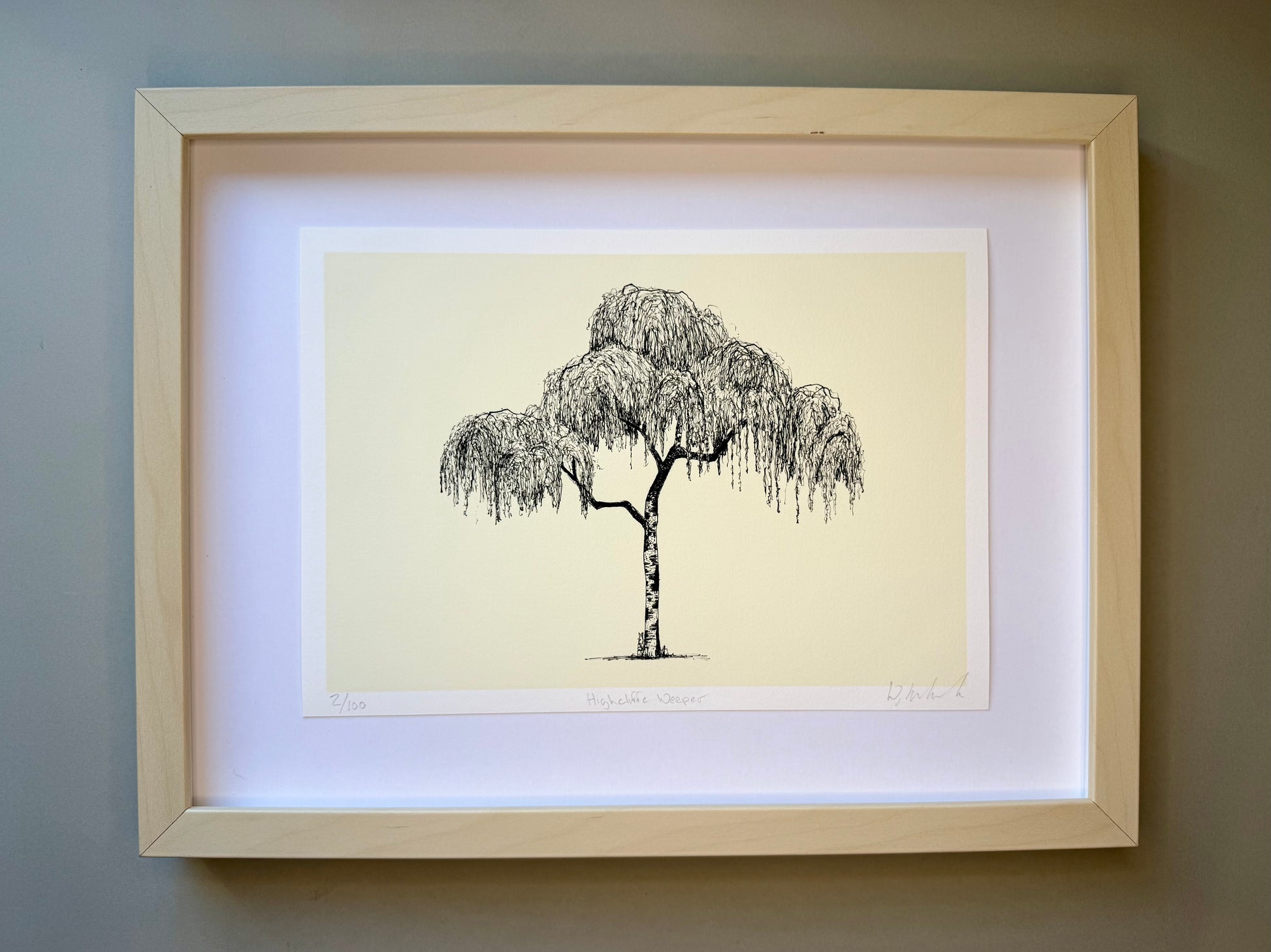 Framed artwork of a tree on a beige background