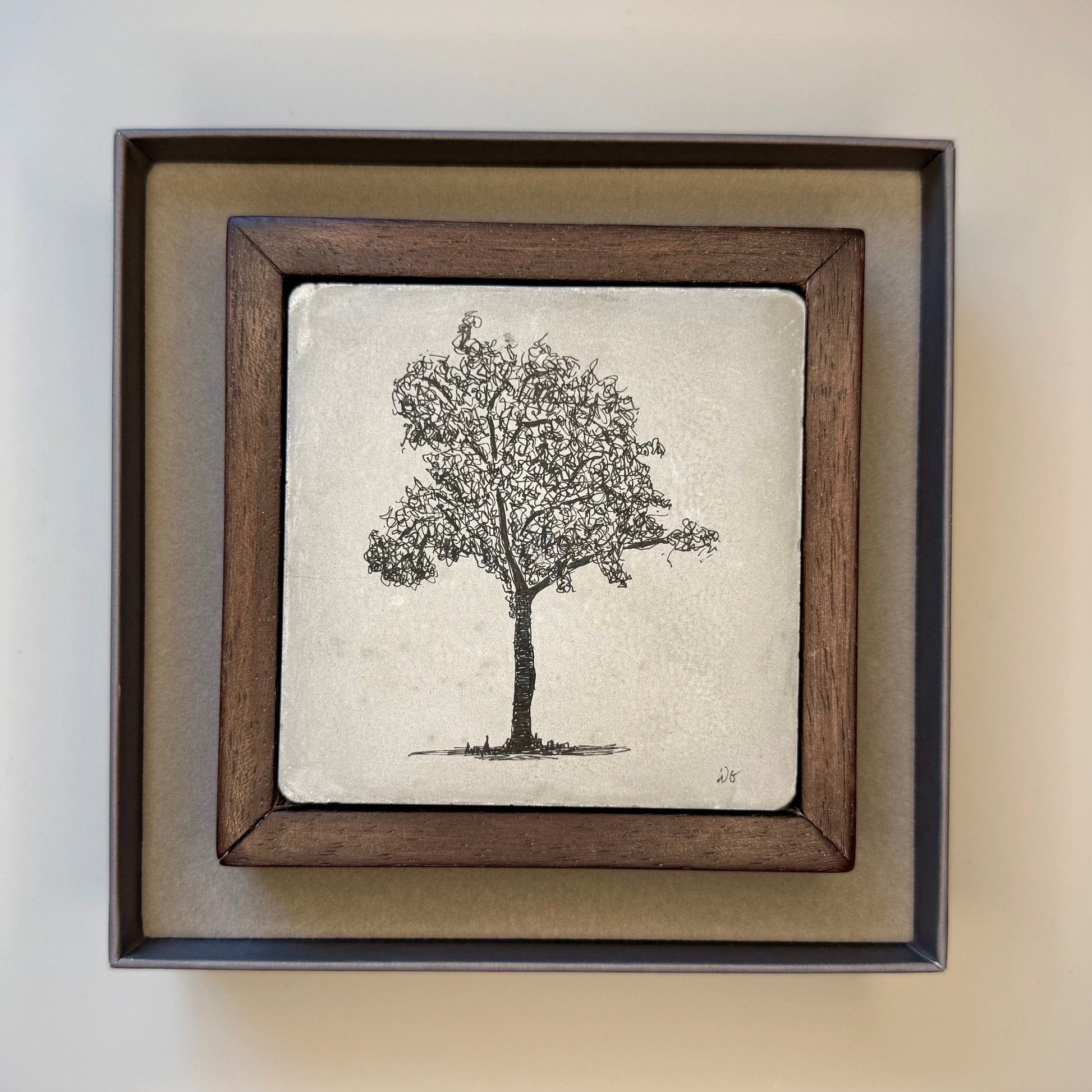 Framed artwork of a tree on a textured background