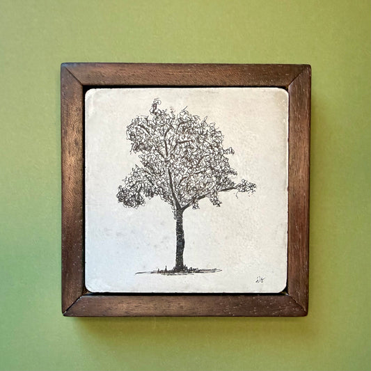 Framed black and white tree illustration on a green wall