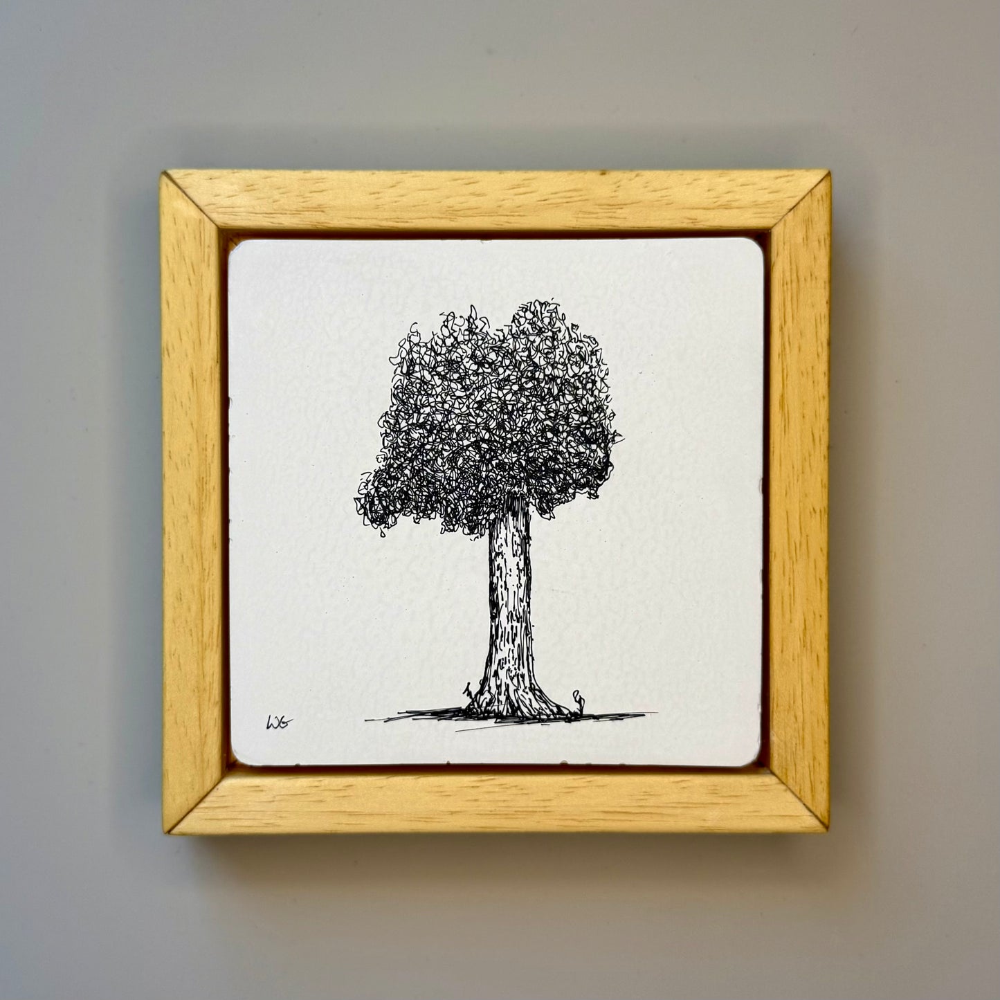 Framed drawing of a tree on a plain background