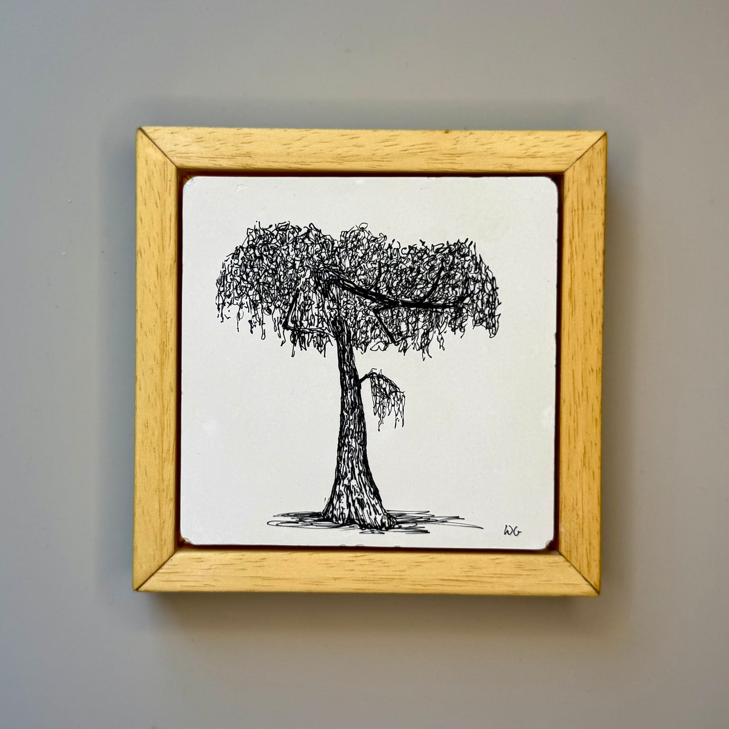 Framed drawing of a tree on a plain background