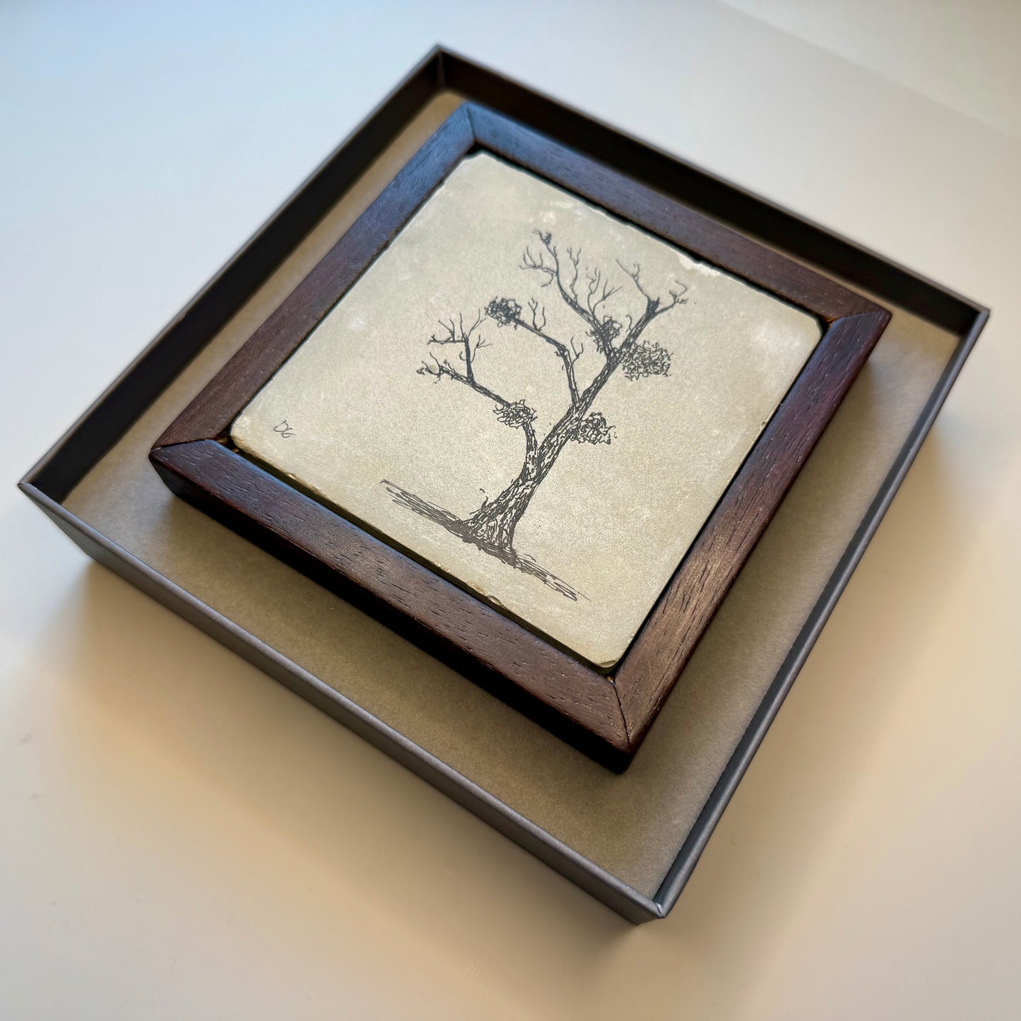 Tree drawing in cement tile in a presentation box
