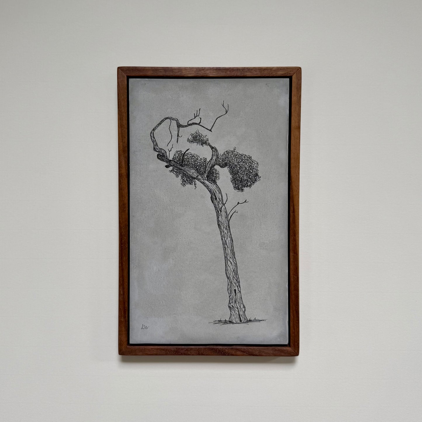 Framed original tree drawing titled Athens, created in ink on cement and photographed hanging on a pale wall.