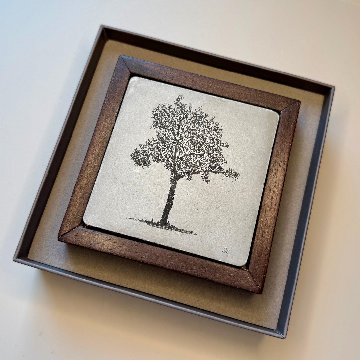 Framed artwork of a tree on a textured background in a presentation box