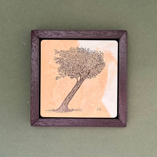 Original ink drawing of a leaning windswept tree on a warm terracotta hand-cast cement tile, framed in a dark walnut-effect wooden frame by Birmingham artist Warren Garland.